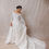 Thumbnail: Model wearing vintage Christian Dior wedding dress against beige backdrop
