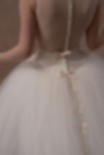 Thumbnail: Model showing side of tulle skirt and satin bow detail of  1996 Vera Wang wedding dress