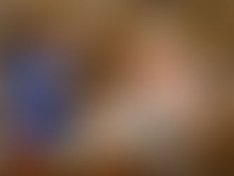 A caregiver and an older adult enjoying tea and a friendly conversation in a comfortable living room, reflecting warmth, connection, and companionship at home.