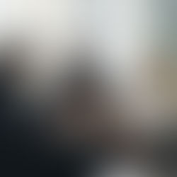 Business leaders in a thoughtful discussion around a coffee table, demonstrating the power of silence and reflective communication in effective leadership and team engagement.