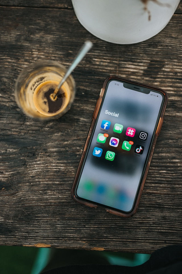 An iPhone that is showing a bunch of social media apps