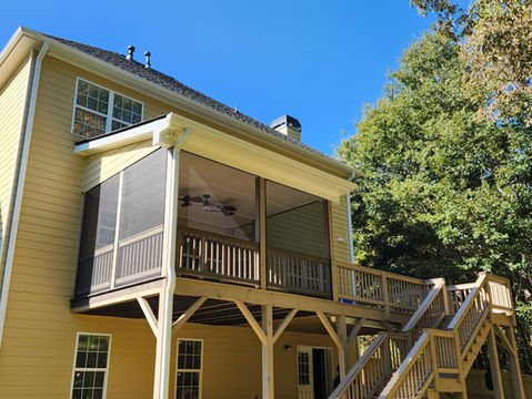 Remodeled screened in deck with an added awning and stairs with handrails.
