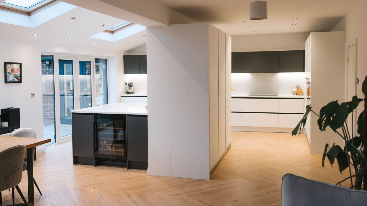 Bespoke modern kitchen in Wirral with white cabinetry, dark anthracite units and quartz worktops