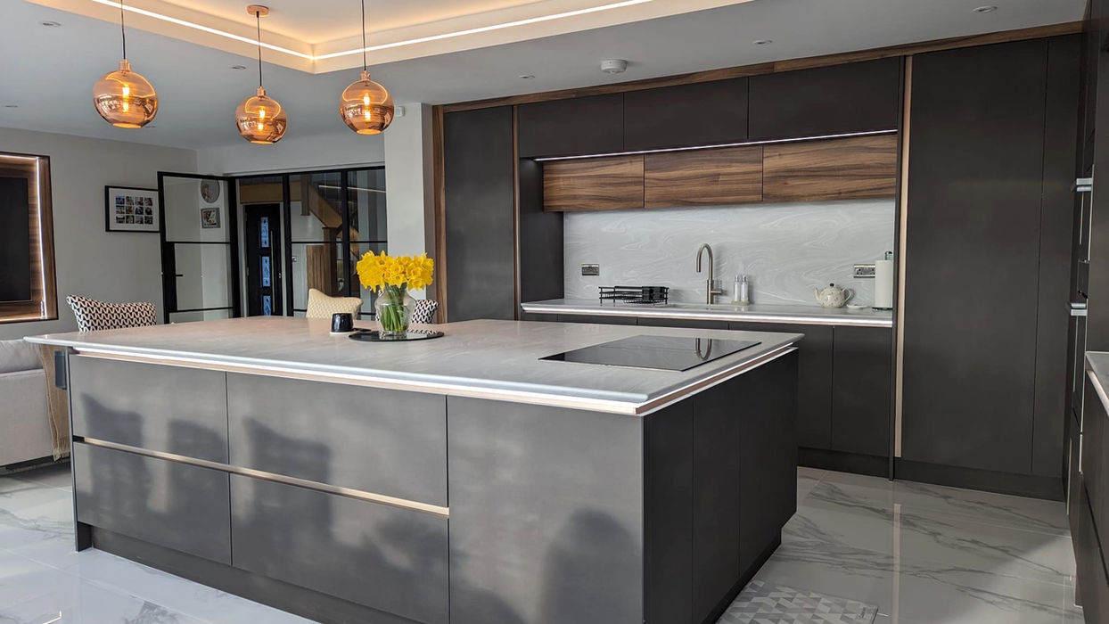Handleless kitchen in Wirral with anthracite metallic cabinets, walnut accents and Grey Onyx Corian worktops