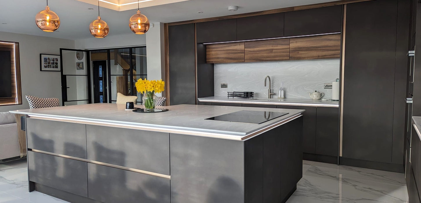 Modern handleless kitchen in Wirral with anthracite and walnut cabinetry and Corian worktops