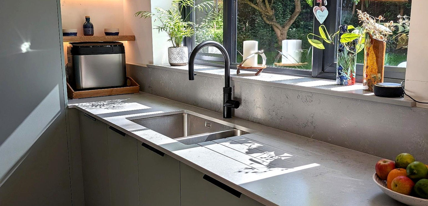 Contemporary kitchen in Cuddington Cheshire with green units, oak flooring and integrated appliances