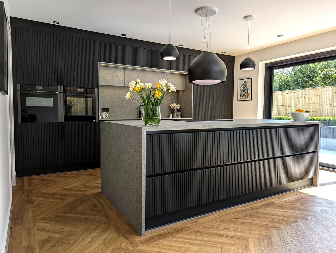 Stockholm kitchen in Wirral with black oak grain cabinets and Boost Mineral Grey ceramic worktops