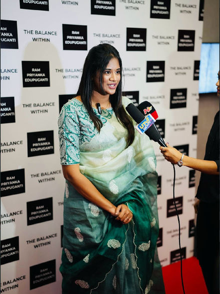 ournalists and reporters surrounding Priyanka Edupuganti for post-launch soundbites.