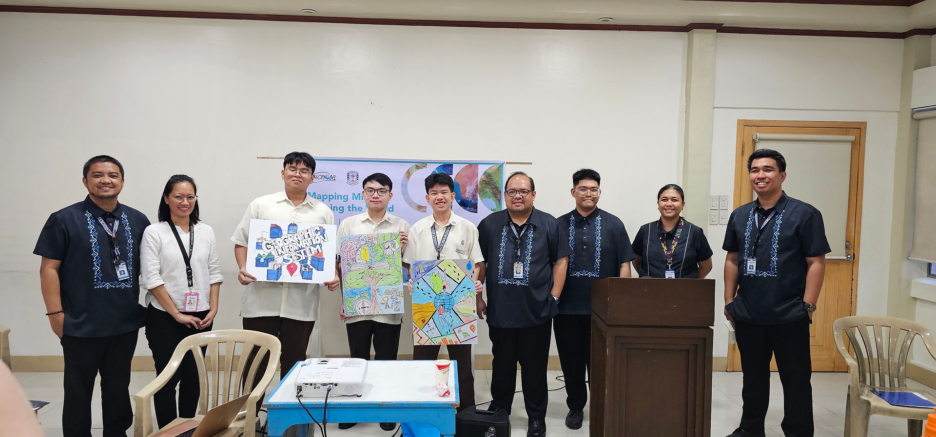 The top three winners of the poster making contest proudly present their award-winning artwork.