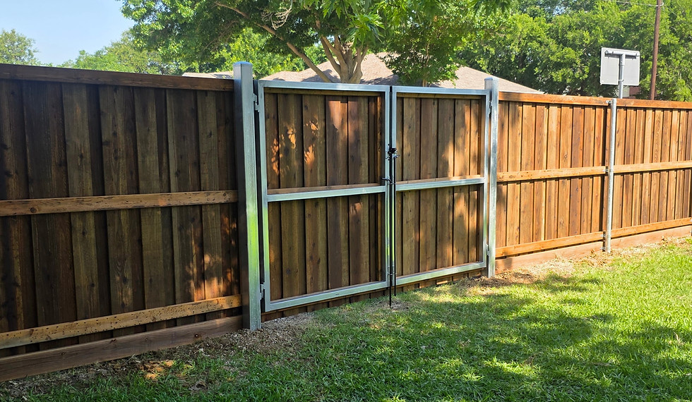 Stained cedar wood privacy fence with metal frame wood gate installed in residential backyard