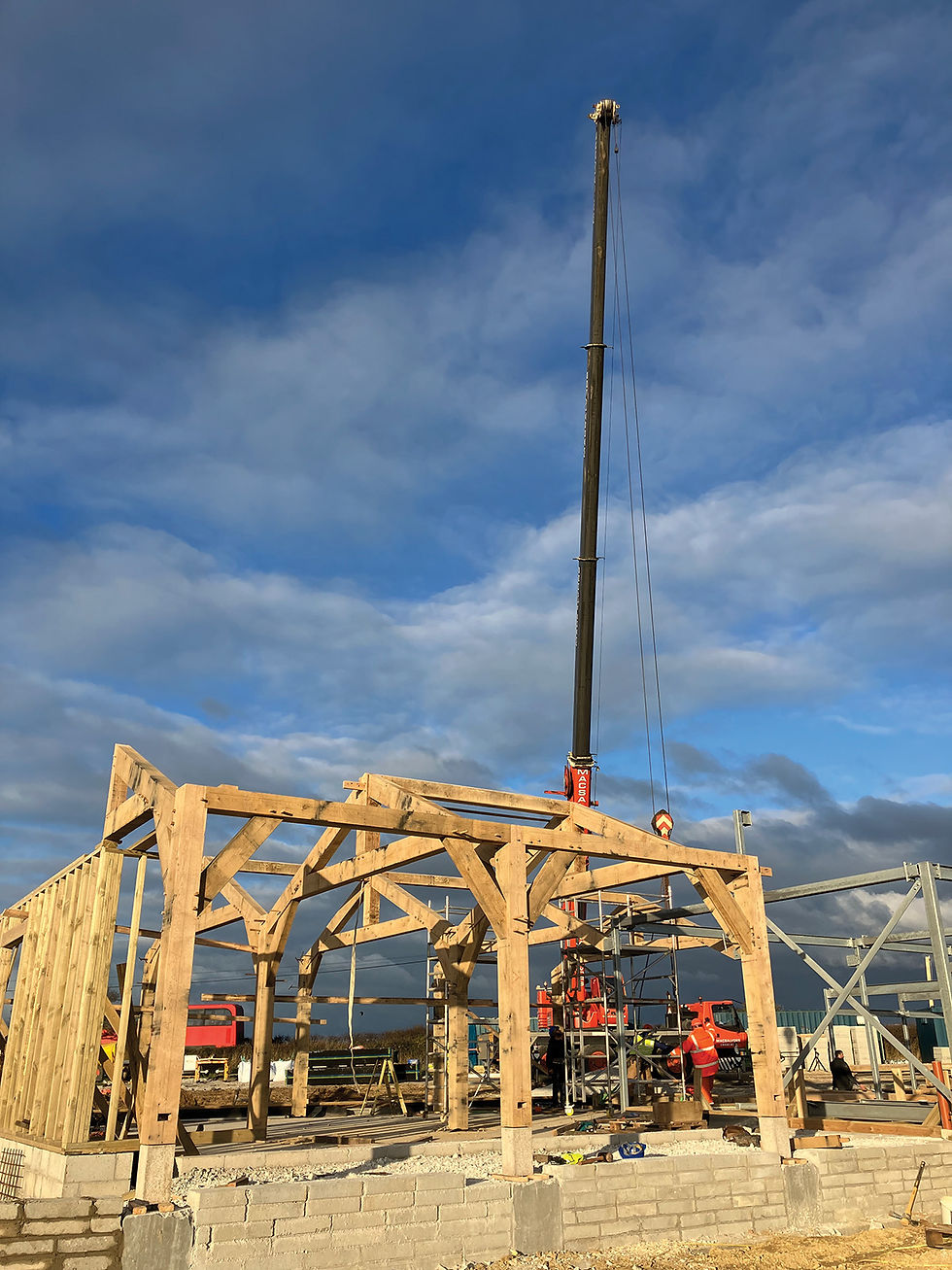 Wooden frame under construction with a crane lifting beams. Workers in safety gear. Bright sky, scattered clouds. Mood is industrious. the Post & Beam Construction process.