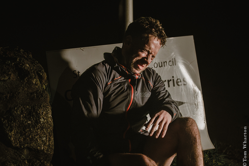 Ultra-runner Mike Samuels competing in the Arc of Attrition 100 in Cornwall, tackling the rugged South West Coast Path between Coverack and Portreath. Set against the dramatic Cornish coastline, the images show steep cliff paths, rocky coves and wild Atlantic seascapes in challenging winter conditions. Battling mud, darkness and coastal weather, he runs across remote headlands and technical terrain during one of the toughest ultra marathons in the UK. Photographed by Tom Wharton, the series captures endurance running in Cornwall, from pre-dawn race starts and windswept coastal trails to moments of exhaustion, resilience and determination during his 100-mile effort and historic out-and-back challenge along the Cornish coast.