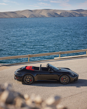 Alt text: Porsche 911 GTS at Porsche Centre Exeter in Devon, showcasing the latest 992 generation Porsche 911 with hybrid assistance technology. Exterior images highlight the wide body stance, dark GTS trim details, distinctive LED light bar and signature 911 silhouette, photographed on Devon roads near Exeter. Interior shots show the driver focused cockpit, low sports seating position, digital instrument display and premium sports car finish. The performance focused yet practical Porsche 911 GTS represents a balance between the Carrera and GT3 models, combining everyday usability with high performance engineering. Available at Porsche Centre Exeter, serving customers across Devon, Cornwall and the South West, this iconic sports car reflects modern Porsche design and driving dynamics in the heart of the region.