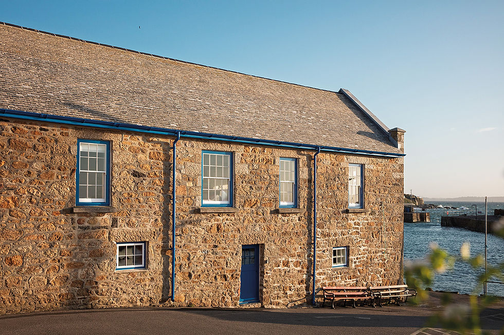 The Grade II Listed Wharf House sits on the edge of Mousehole Harbour