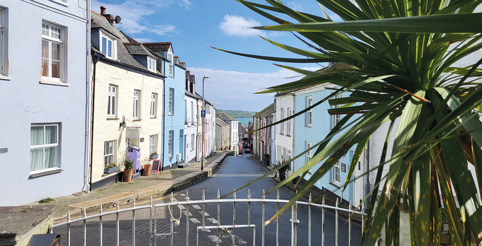 The Cross House, a Grade II listed property in Padstow old town, North Cornwall, positioned on a prominent corner just moments from Padstow Harbour, restaurants and cafés. This substantial period home spans three storeys and retains original features including tall sash windows, high ceilings and wooden floors that reflect its historic character. Interior images show spacious reception rooms filled with natural light, a traditional kitchen and utility area, and seven double bedrooms, six with en suite bathrooms, plus an additional bedroom with private shower room. Outside, the property benefits from a front garden overlooking Padstow and rare off road parking, making it a versatile coastal home in one of Cornwall’s most sought after harbour towns, marketed by Jackie Stanley estate agents.