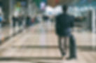 businessman-carrying-suitcase-while-walking-through-passenger-departure-terminal.jpg