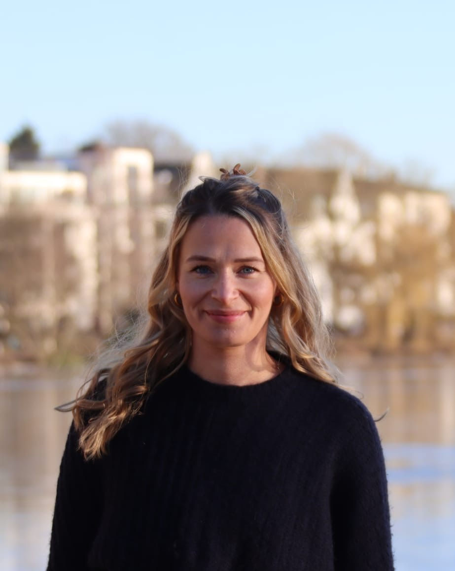 sara vordermeier smiling with a lake in the background