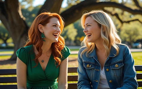 two women sisters in their 30s chatting on a bench at a park.jpg