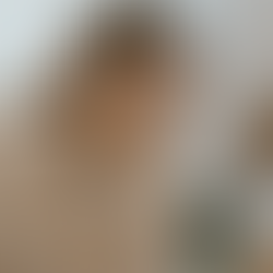 Woman sitting indoors with her head in her hands, showing signs of stress or emotional distress