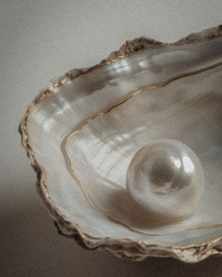 Shiny pearl inside an open shell with irregular edges