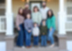 Multi-generational family posing on porch steps