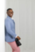 Smiling photographer in blue blazer holding a camera