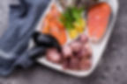 A vibrant seafood platter featuring oysters, calamari, shrimp, and mussels, beautifully arranged with lemon wedges and fresh herbs for a feast of ocean flavors.