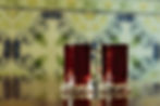 Two elegant glasses of red wine, their rich ruby hues glowing softly in the light.