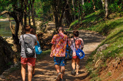 Visitors hiking jungle trail at Semuc Champey Lanquin Guatemala