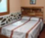 Interior of fourth room with wooden door at El Retiro Lodge LanquÃn Guatemala