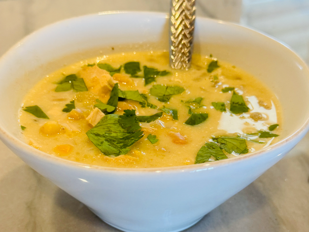 A bowl of white chicken chili with cilantro garnish