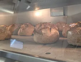 Sourdough loaves baking in the oven at Fermento Bakery