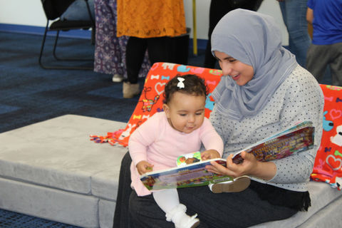 Child and parent with book