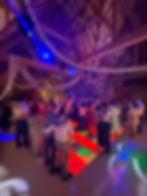 DJ Ollie Clarke performing at a wedding at Red House Barns guests on the dance floor