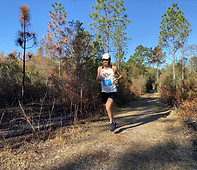 a runner on a grassy trail during the 30a 50k