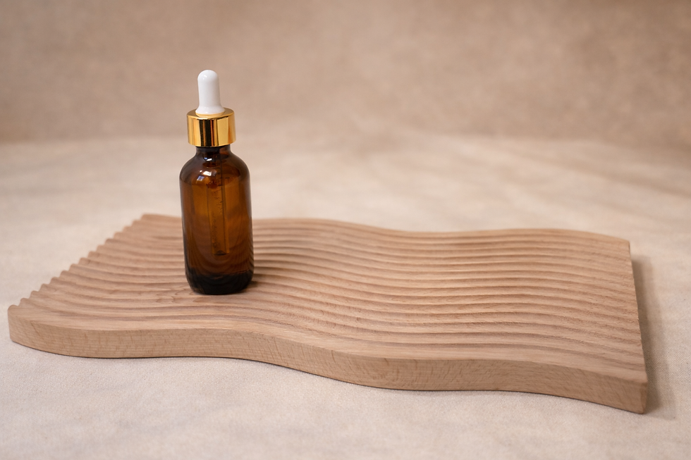 Barbers Reserve beard oil in an amber glass dropper bottle displayed on a natural wood tray with warm neutral styling.