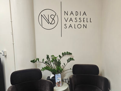 Nadia Vassell Salon and logo wall inside the salon