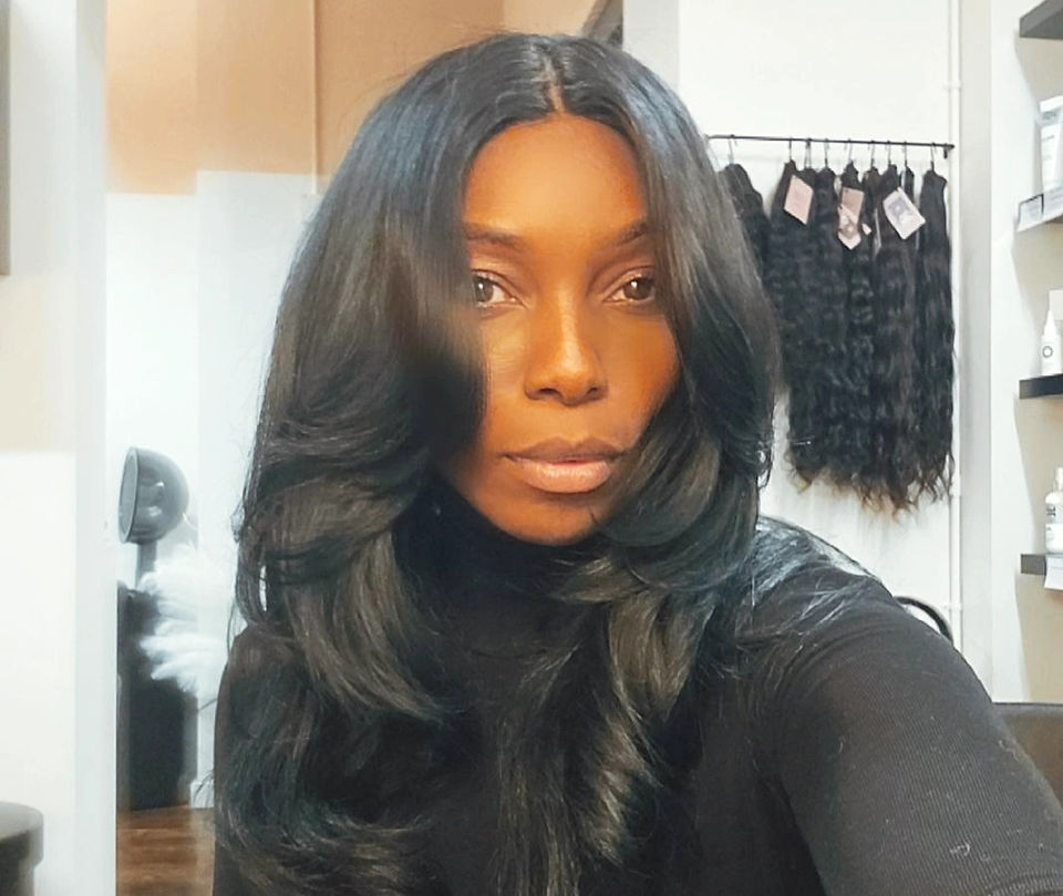 Woman wearing a part in the middle weave installation