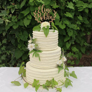 Buttercream finish with fresh edible foliage and flowers