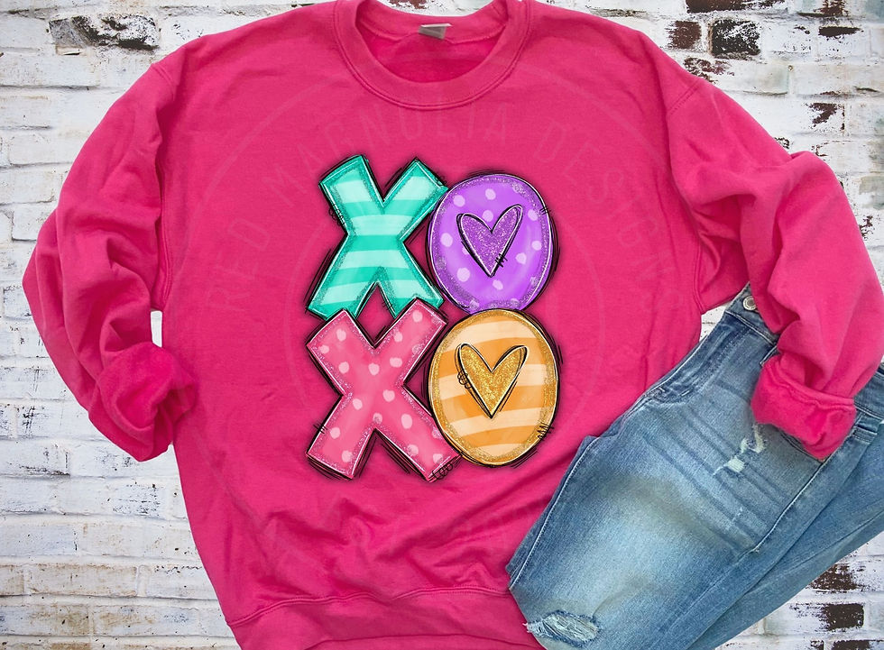 Pink Valentine’s Day sweatshirt with colorful XO letters and heart design hanging on a hanger.