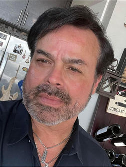 This image shows a picture of Adrian Escobedo, who is a health inspector, proctor and owner of ServIt Safe