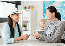 Two workers smiling and chatting at a table