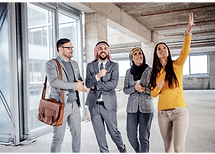 A group of people standing together and examining a developing building