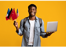 A smiling student holding a laptop and flags of the world