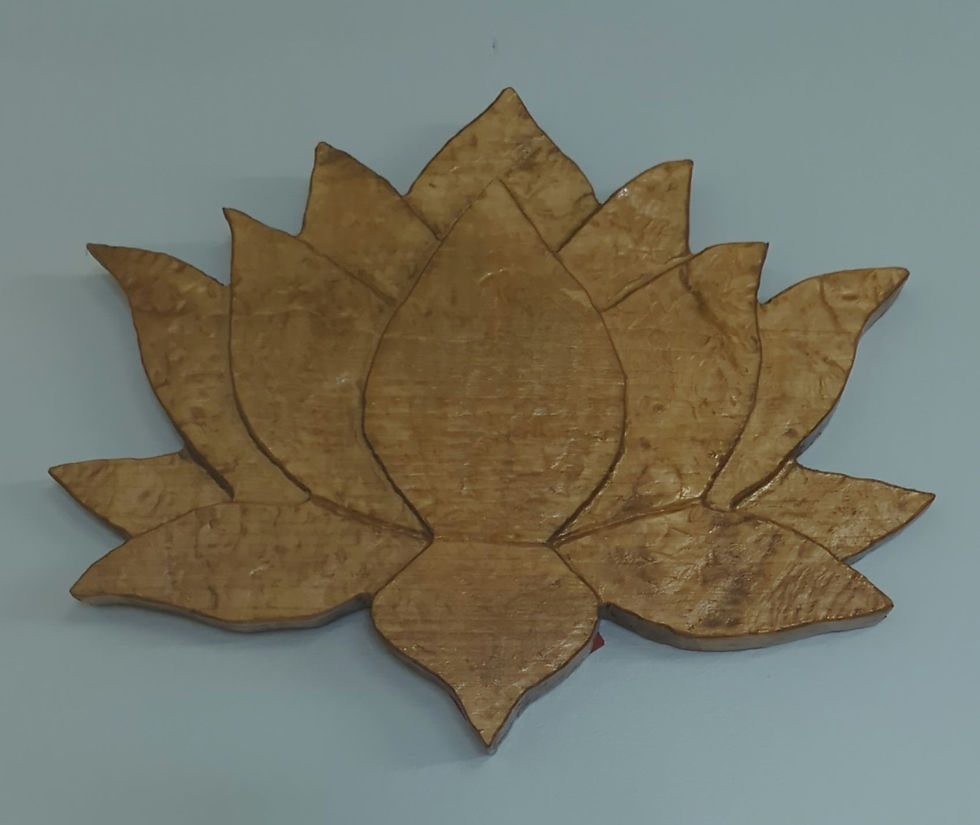 Wooden lotus flower carving on a light blue wall; warm brown tones with a textured, rustic finish; calming and serene atmosphere.