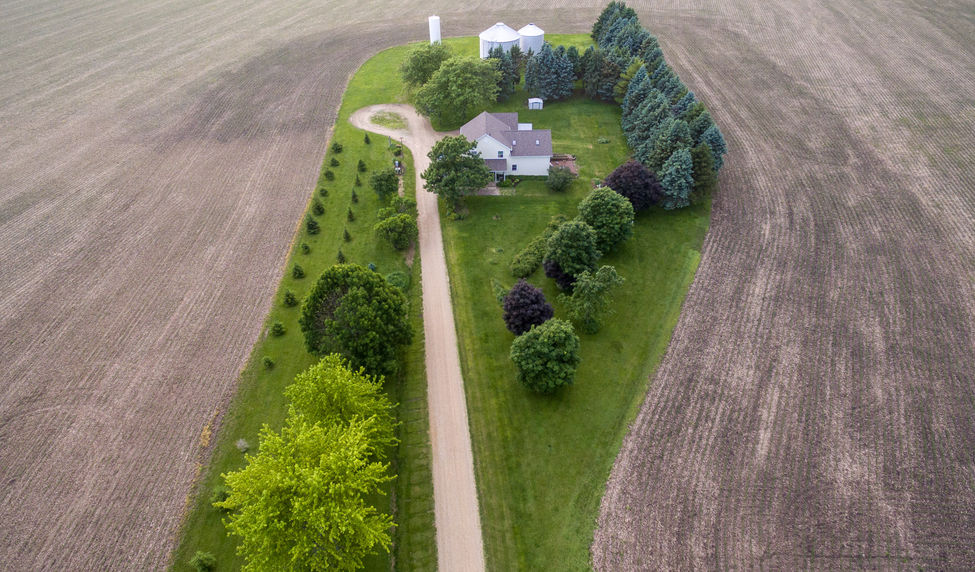 aerial view of farmhouse and corn field