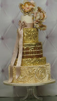Custom edible gold sequin, rosettes and naked wedding cake with gold drips by sweet confections cakes
