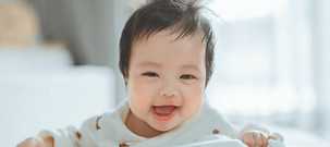 cute asian baby on his tummy smiling