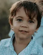 young child looking into the camera with a smile