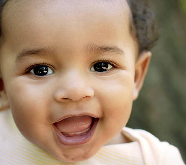 a mixed race toddler, smiling a wide open smile
